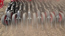 Farming Cultivator At Work, Close-up Of A Cultivator Machinery In A Farm Field.