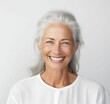 Elderly female with gray hair joyfully smiling looking directly at the camera lens. Ai generated
