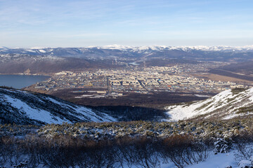 Wall Mural - View from the mountain to the city of Magadan. A large northern city located on the sea coast among the mountains. Beautiful northern nature. Magadan, Magadan region, Russian Far East.