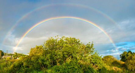 Wall Mural - Spectacular double rainbow over the picturesque landscapes of rural inland Algarve, Portugal