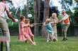 © Halfpoint - Grandparents have a tug of war with their grandkids. Fun games at family garden party.