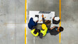 © Halfpoint - Top view of full team of warehouse employees in warehouse. Team of workers, managers, female director in modern factory, heavy industry, manufactrury.