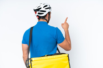 Wall Mural - Young caucasian man with thermal backpack isolated on white background pointing back with the index finger