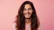 © Z A C - Smiling man with long hair and glasses wearing a pink shirt against a pink background.