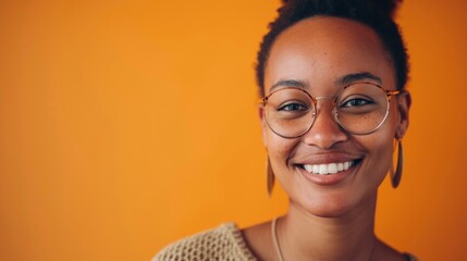 Poster - Smiling woman with glasses and earrings against orange background.