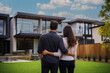 © Miro Nenchev - Lovely couple in front of a new house buying new home, real estate concept