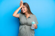 © luismolinero - Pregnant woman on blue background has realized something and intending the solution