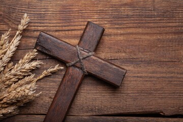 Poster - Wood cross and golden wheat on desk