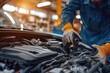 © ffunn - Auto mechanic working on car broken engine in mechanics service or garage