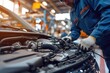 © ffunn - Auto mechanic working on car broken engine in mechanics service or garage