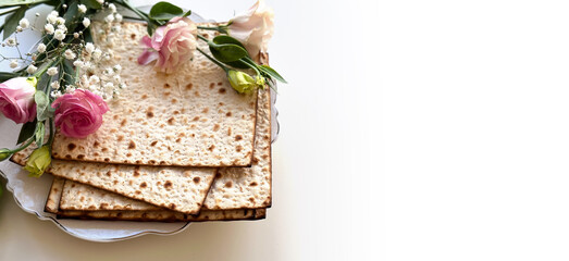 Wall Mural - Passover. Holiday of Jewish people. Traditional Matzo prepared for Passover decorate by flowers on white background. top view. Spring Holiday. Fasting time