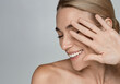 © Peakstock - Laughing woman having perfect and glowing skin, beauty portrait. Advertising of skincare products and aesthetic cosmetology