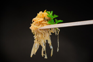 Wall Mural - cabbage stewed with spices and carrots on a wooden fork