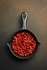 Wall Mural - Spices. Fragrant red pepper peas in a black bowl. On a dark background. Top view.