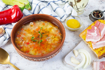 Wall Mural - Minestrone soup. Vegetable soup with grilled bread, ham and spices