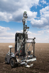 Fototapete - Autonomous robot for measuring soil quality in an agricultural field. Smart farming concept