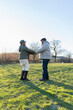 © Cultura Creative - Senior couple holding hands, standing in meadow
