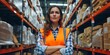 © MADNI - Woman posing in orange vest in logistics center warehouse