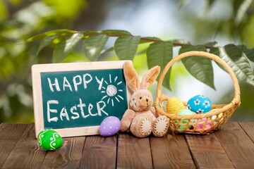 Sticker - Painted colored Easter eggs and bunny on the desk