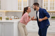 © New Africa - Happy lovely couple dancing together in kitchen