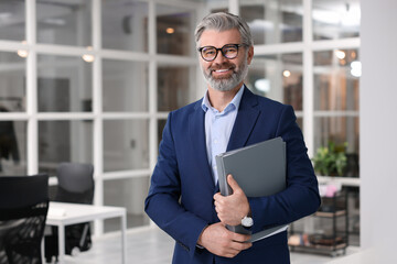 Poster - Portrait of smiling man with folder in office, space for text. Lawyer, businessman, accountant or manager