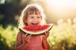 kid eating watermelon outdoors in hot summer
