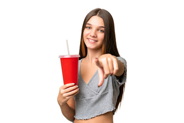 Wall Mural - Teenager caucasian girl holding a soda over isolated background points finger at you with a confident expression