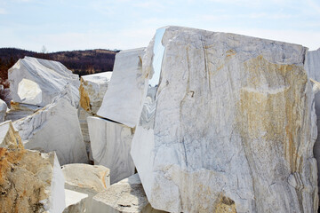 Large white marble blocks in an old abandoned quarry in the village of Buguldeika. Beautiful marble texture 