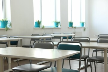 Wall Mural - Empty school classroom with desks, windows and chairs