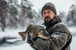 fisherman with a big caught fish trophy on a frozen lake in winter