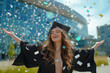 Joyful Graduate Celebrating with Confetti Toss. Happy graduate in graduation gown and cap celebrating with a confetti toss outdoors.