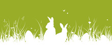 Easter Banner With Easter Bunnies And Easter Eggs On The Grass. Green Easter Background With Meadow Silhouette, Flowers, Herbs, Butterflies Ans Bees.