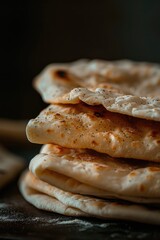 Poster - A stack of flat bread placed on top of a table. This image can be used to showcase different types of bread or in a food-related context