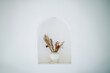 Dried Flowers in a white vase in an alcove