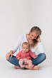 © RenaMiller - Mother sitting on the floor looking down to baby on her lap