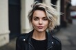 Portrait of beautiful young woman in black leather jacket with flying hair