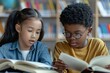 © Marina - Two school kids sitting in a classroom, reading textbooks.