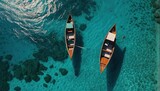 Fototapeta Sport - View from above, stunning aerial view of two long tail boats floating on a turquoise water