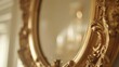  a close up of a gold framed mirror with a window in the back ground and a window in the back ground and a wall to the side of the mirror.