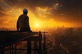 Fototapeta Sypialnia - worker at sunset with safety helmet