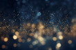 Golden abstract background with glittering gold dust particles and glittering lights and bokeh effect, dark blue background