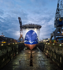 Poster - Large seismic offshore research ship in dry dock after painting hull surrounded with industrial cranes with water reflection