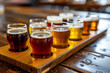 detailed view of a beer flight. Several small glasses of different types of beer are arranged on a wooden paddle
