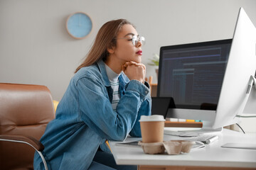 Sticker - Female programmer working with computer at table in office