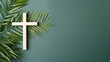 Christian cross and palm leaf on a neutral background with copy space