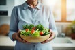 unrecognizable older woman holding a healthy plate of vegetables