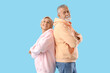 © Pixel-Shot - Mature couple in hoodies on blue background