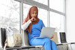 © Pixel-Shot - Female Muslim medical intern with laptop in clinic