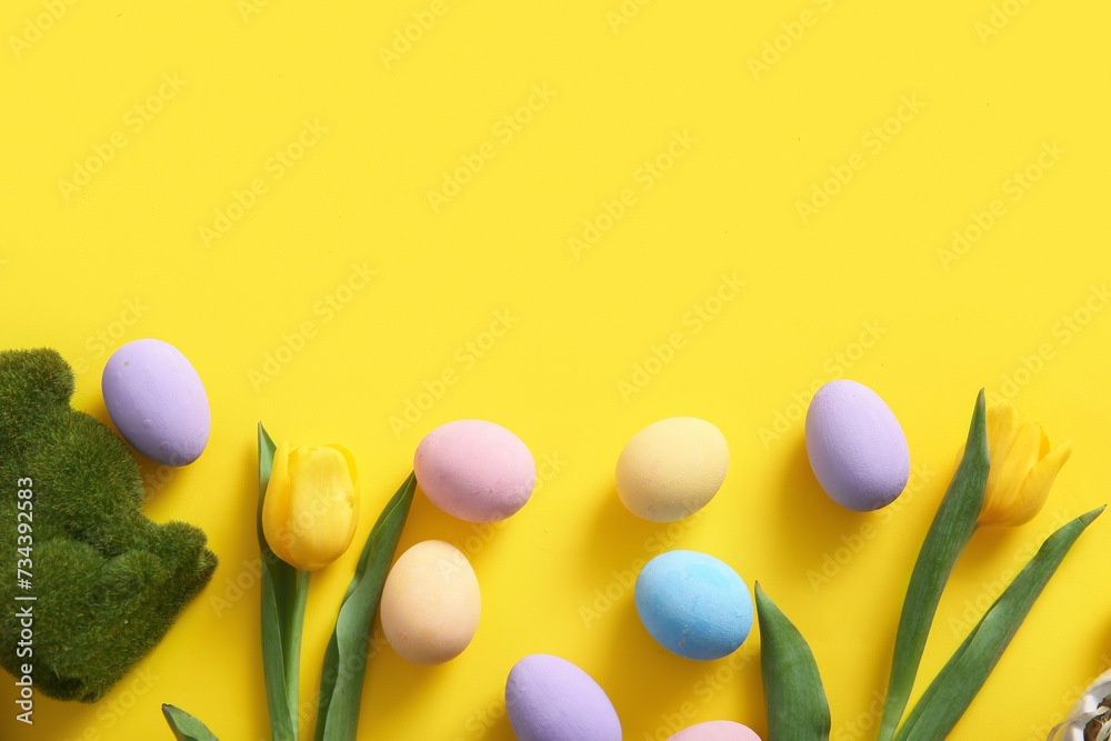 Painted Easter eggs with tulip flowers on yellow background