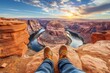 A daring hiker stands on the edge of a rocky cliff, jeans caked in dirt, overlooking a vast canyon landscape as clouds drift lazily through the bright blue sky above